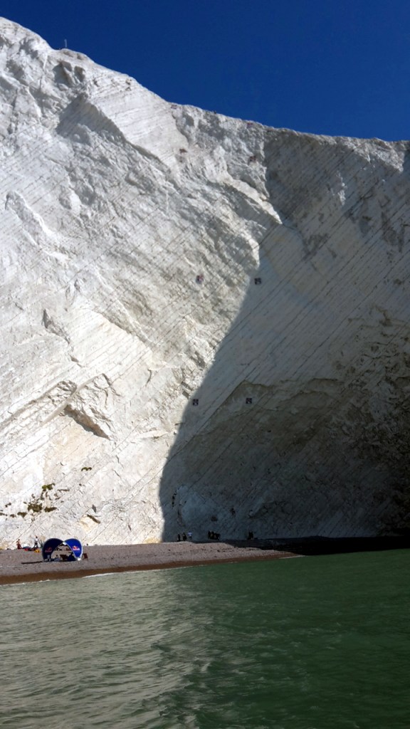 The impressive 100m chalk wall, vertical left route for the females, overhanging right route for the males.